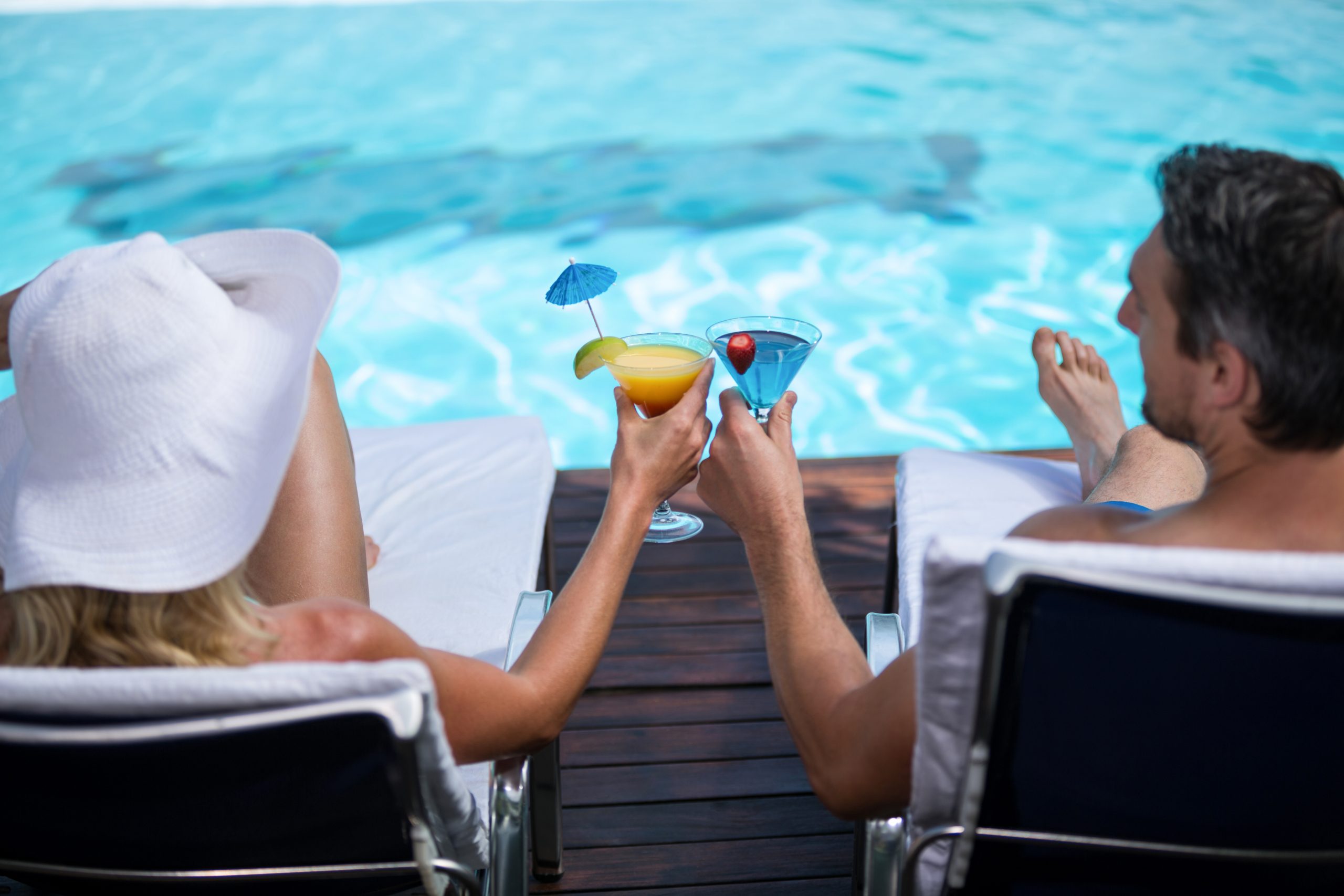 703934 Couple by pool for their as first-time visitors Turks and Caicos