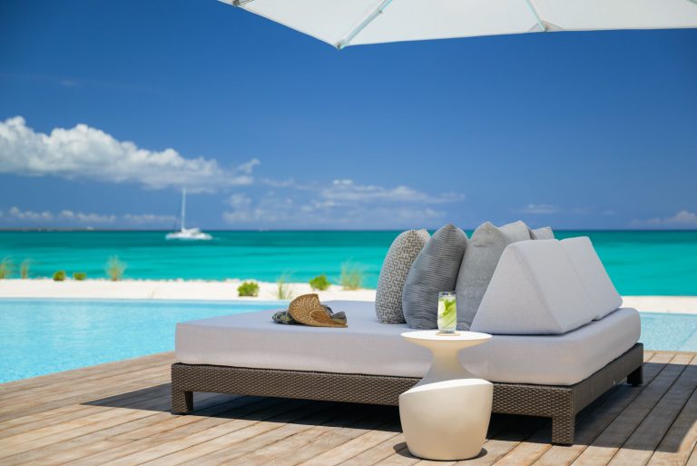 Spa bed beside outdoor pool for a wellness retreat